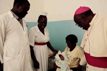 Board of Governors chairman E G Arch Bishop J B Odama visits maternity ward. Dr Paul Buga and Sr. Anna accompany him.